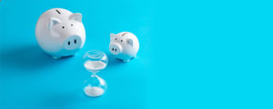 two piggy banks and hourglass